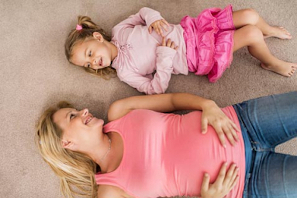 Embarazada tumbada con hija